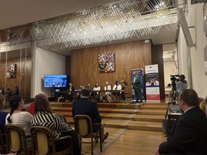 Saal im Parlament mit Gästen, die sich das Projektvideo ansehen